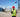 A surveyor standing in a construction site holding  survey pole