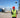 A surveyor standing in a construction site holding  survey pole